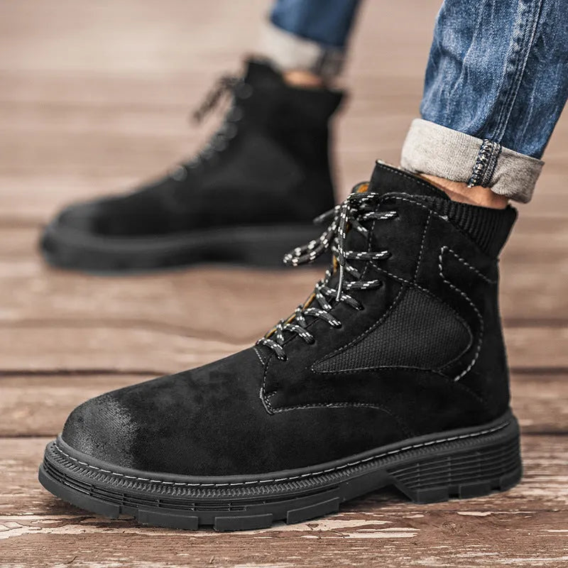 Men's frosted brown Martin boots with round toe and thick rubber sole on a wooden surface.