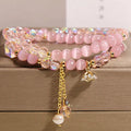 New Chinese style gold-plated double ring bracelet with pink cat eye crystal and zircon small flower detail
