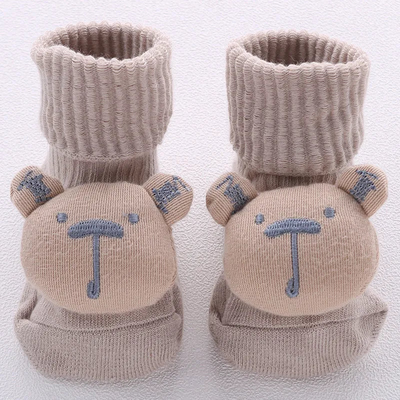 Cotton baby floor socks in assorted colours and prints like blue bow and pink stars on a size chart.
