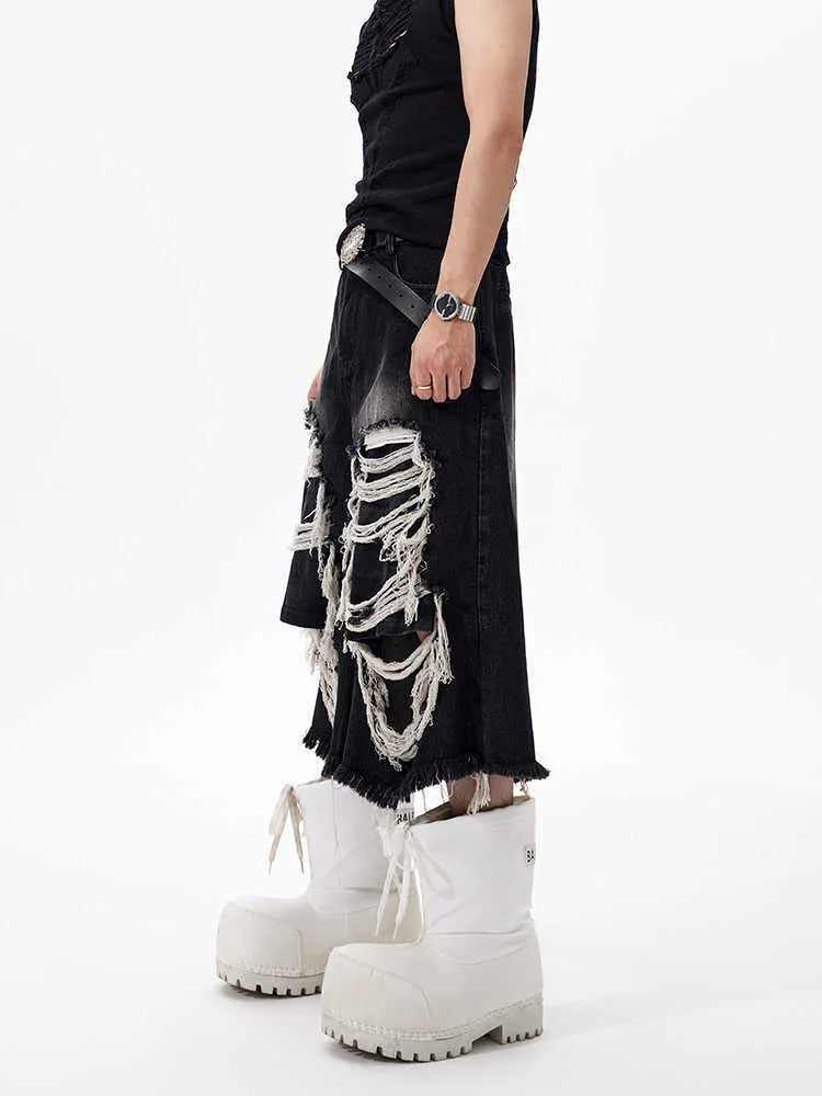 Black women's cropped wide-leg jeans with a mid-high waist and ripped patch details on a loose fit.