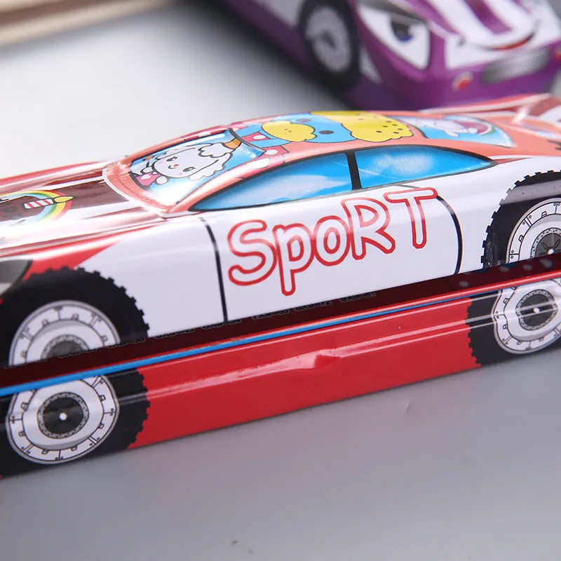 Red and blue cartoon race car design metal pencil case with double-layer trolley shape, shown with pens inside.