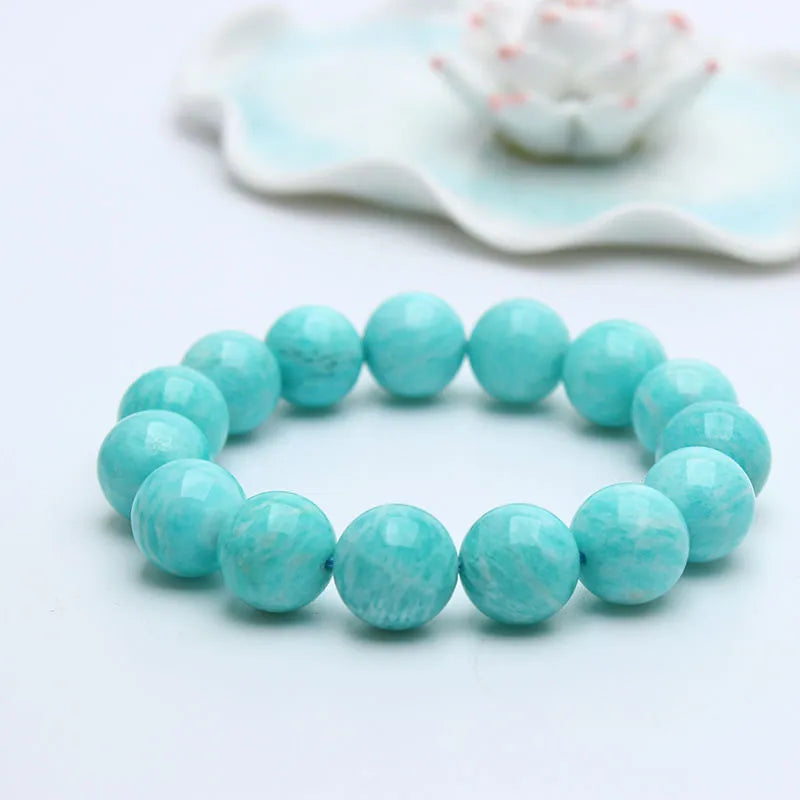 Natural blue-green Amazonite gemstone bracelet with adjustable closure on a wrist.