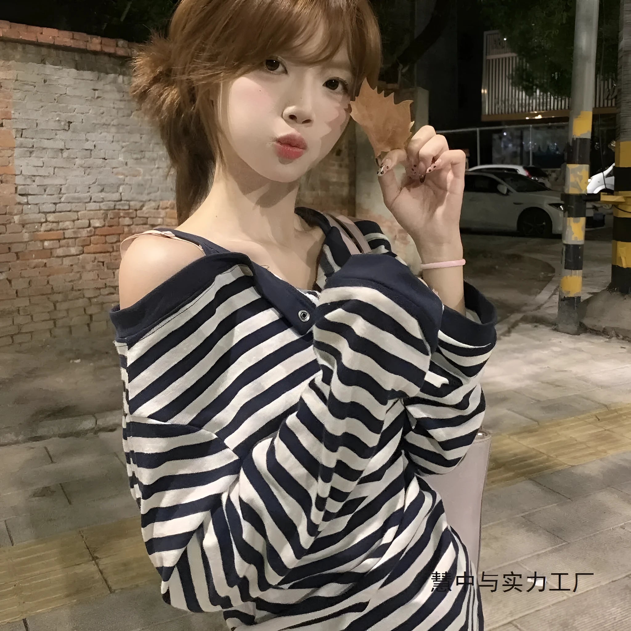 Dark blue women's oversized long-sleeved T-shirt with embroidery and stripes, laid flat.