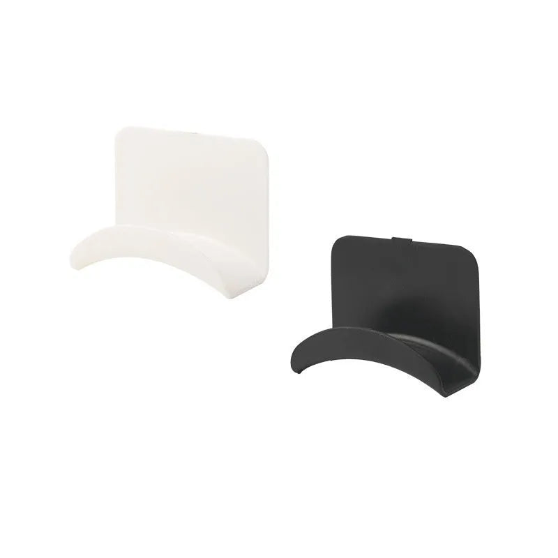 Black plastic headphone bracket mounted on wall with universal fit for headset storage