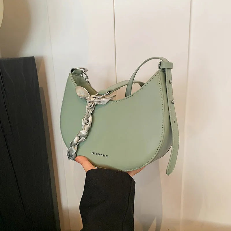 Small PU saddle shoulder bag with sandwich pocket and phone compartment, shown in black, brown, coffee, green, khaki or white.
