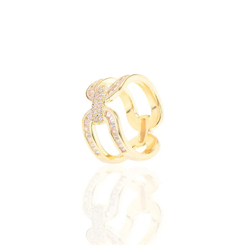 Gold electroplated copper round scarf ring with geometric shape on a silk scarf