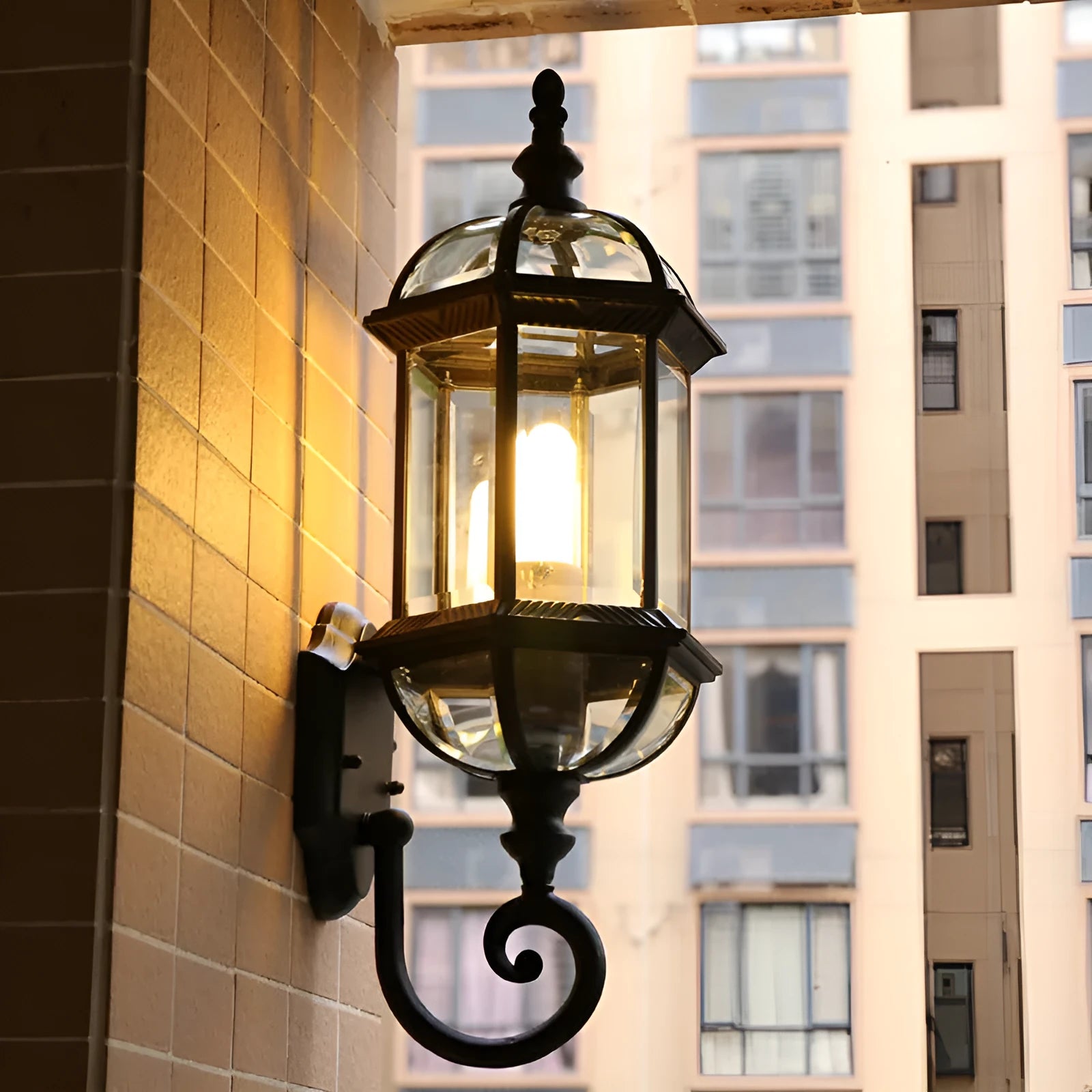 Gold aluminium outdoor wall lamp with three-layer design mounted on a brick wall.