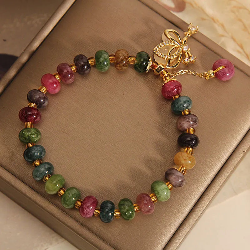 Colourful bead bracelet with alloy butterfly charm for women showing adjustable length