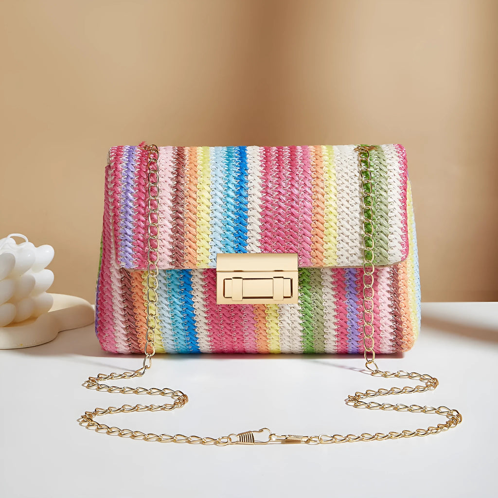Soft woven straw women's cross-body bag in a small square shape, shown in rainbow colour with a single shoulder strap.