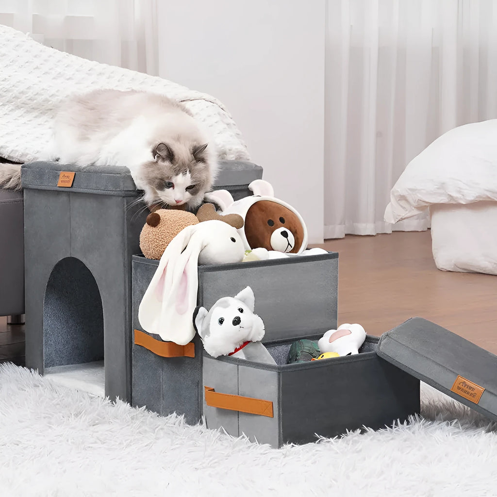Foldable gray cloth pet storage stairs with two or three steps, placed next to a bed for dog access