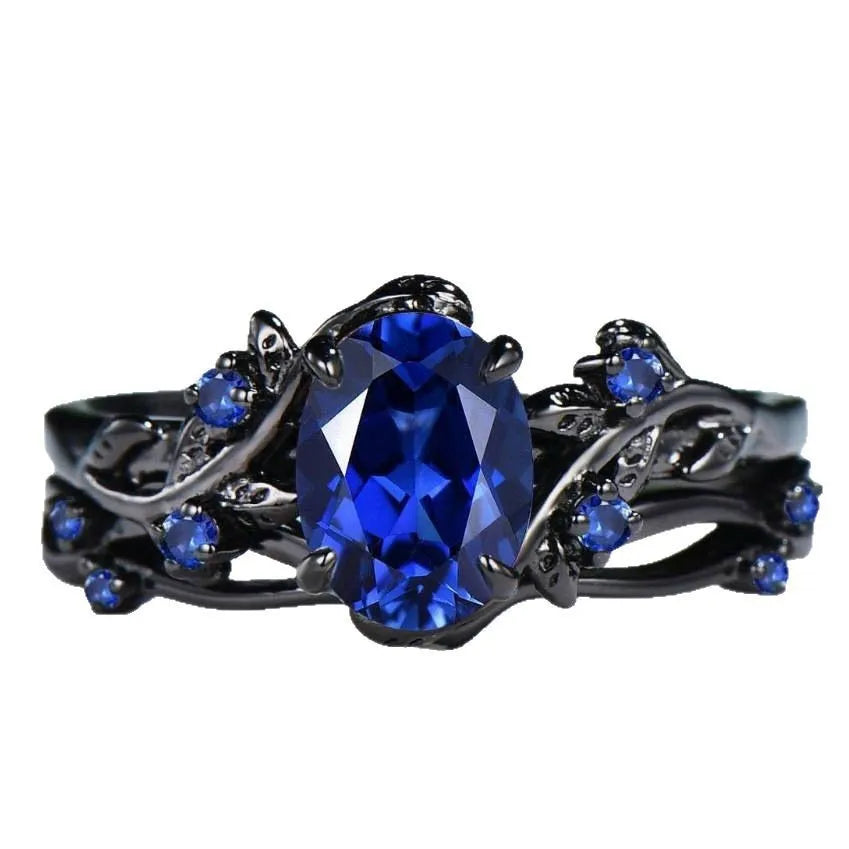 Gun black geometric copper women's ring with an inlaid navy blue rhinestone, shown in size 10.