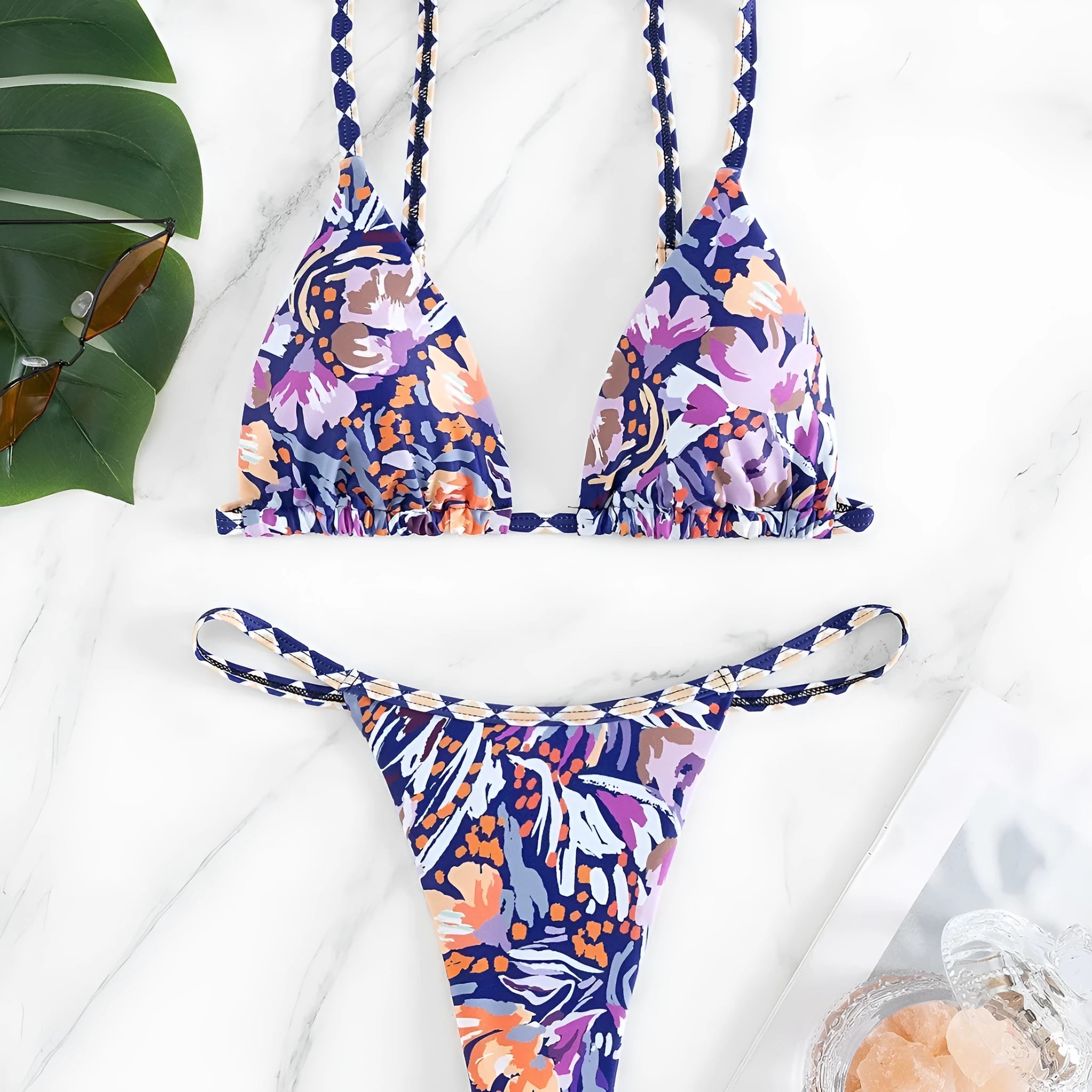 Women's floral print triangle top bikini swimsuit with briefs style bottoms in polyester fabric.