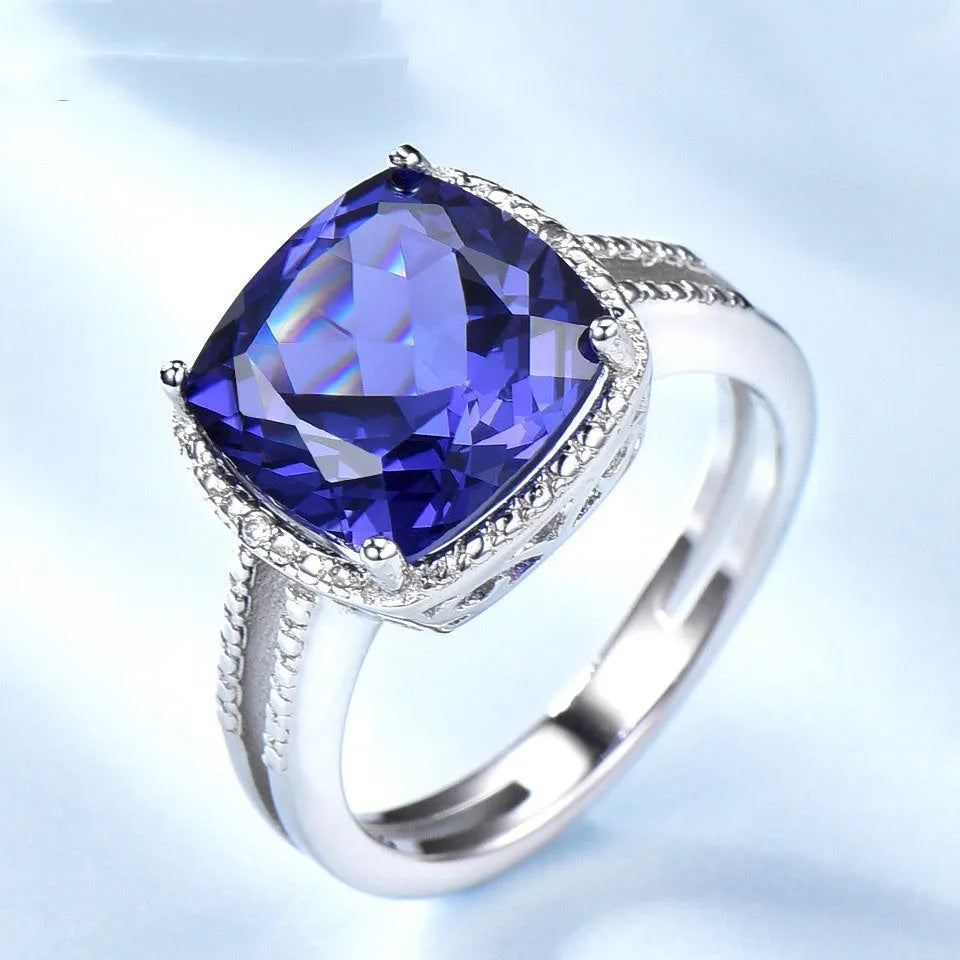 Women's sterling silver ring with a blue tanzanite gemstone on a silver band.