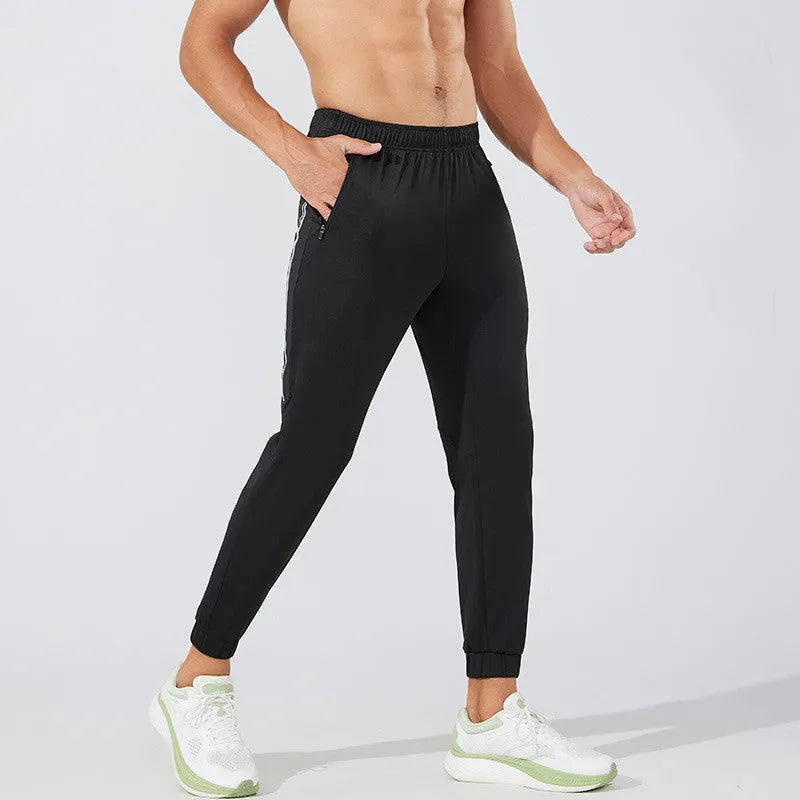 Men's black breathable polyester running trousers with a mid-waist design.