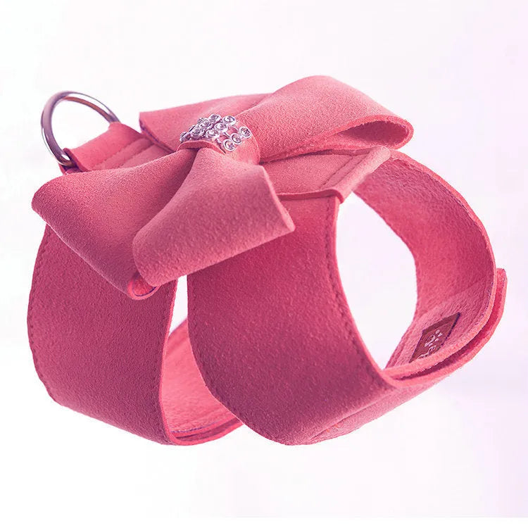 A pink microfiber dog chest strap with a decorative bow, sized for a small puppy.