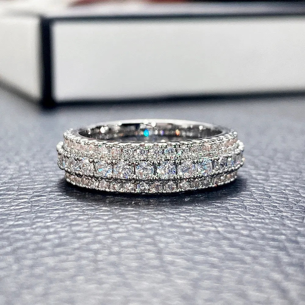 Triangular geometric ring with a zircon stone centre, shown in different metal plating colours.