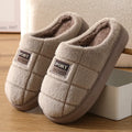 Men's grey and brown plaid rabbit hair slippers with thick lining and a textured EVA sole.