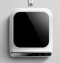 Black USB cup warmer with temperature controls and reminder light on desk