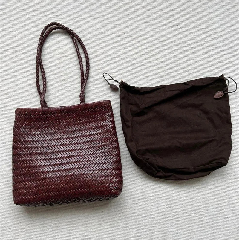 Brown handmade woven cowhide leather tote bag with a three-dimensional outer pocket.