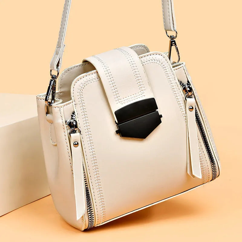 Small square vertical women's handbag in soft textured PU leather, shown in multiple colour options.