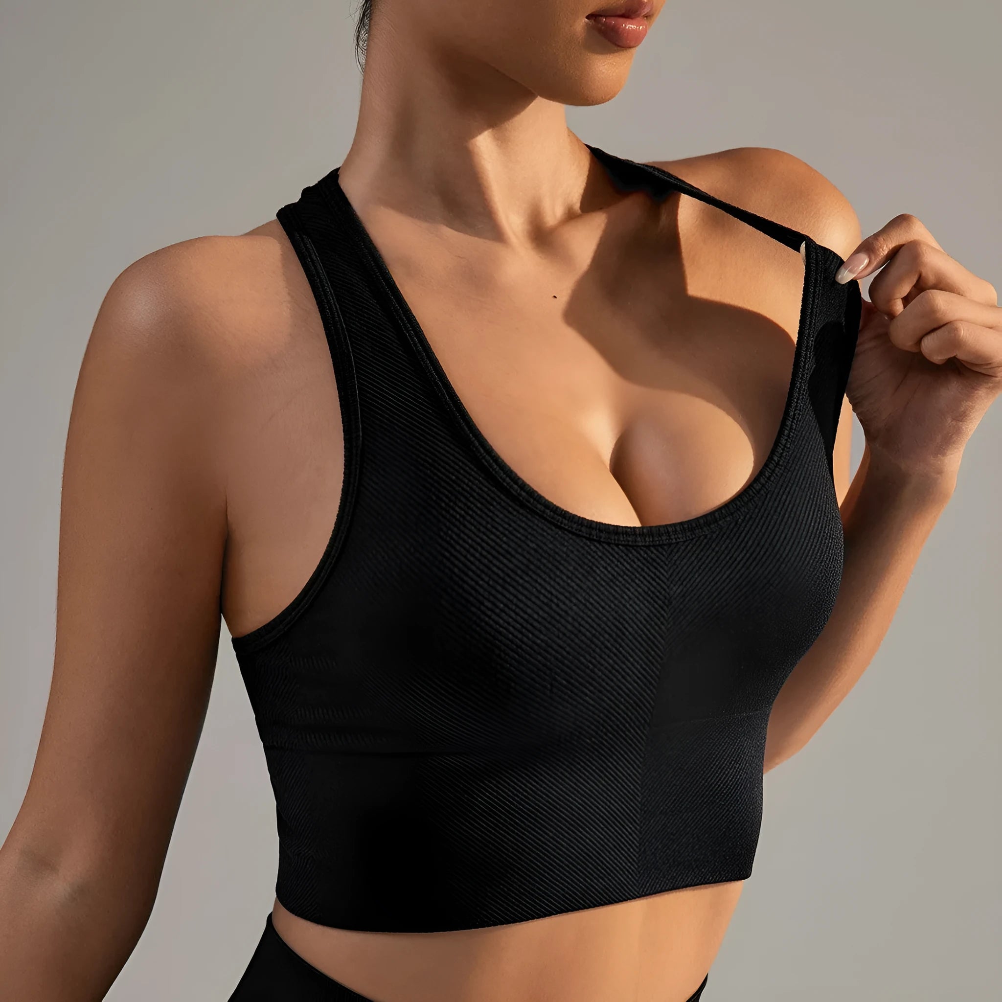 Black women's sports bra with a cross beauty back design and double shoulder straps.