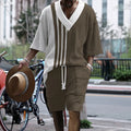 Men's grey printed knitted shorts suit with drop-shoulder short-sleeved top on a hanger.