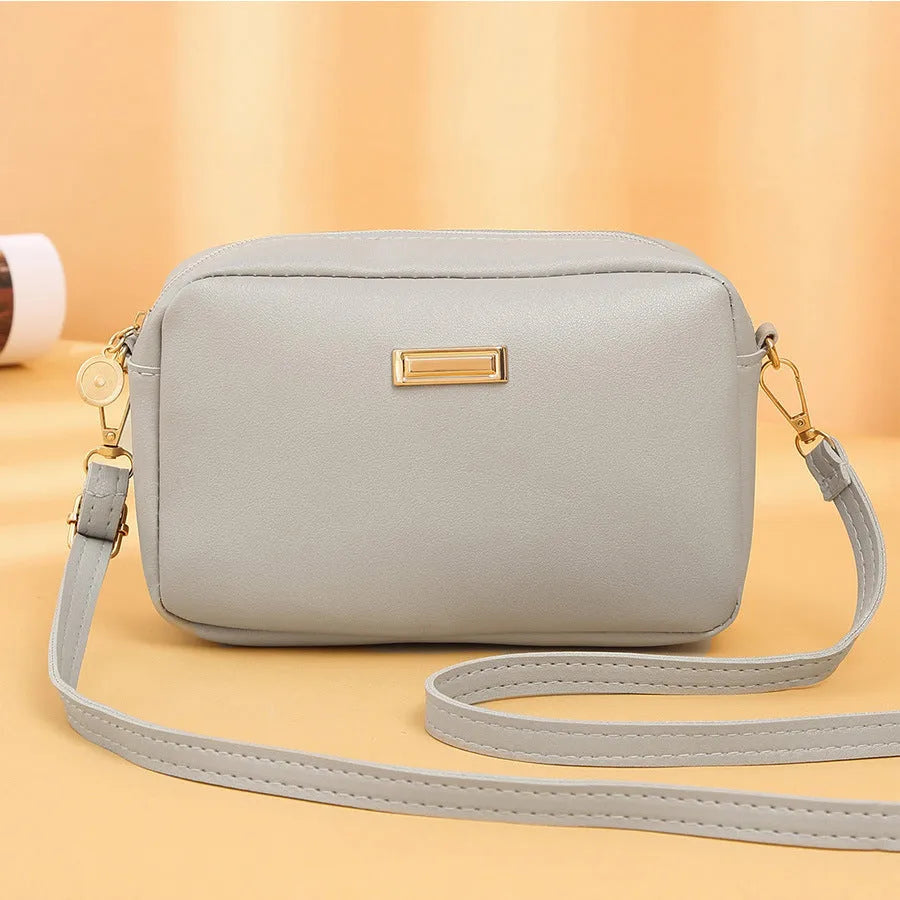 Women's solid colour PU shoulder bag with three-dimensional pocket in urban simplicity design
