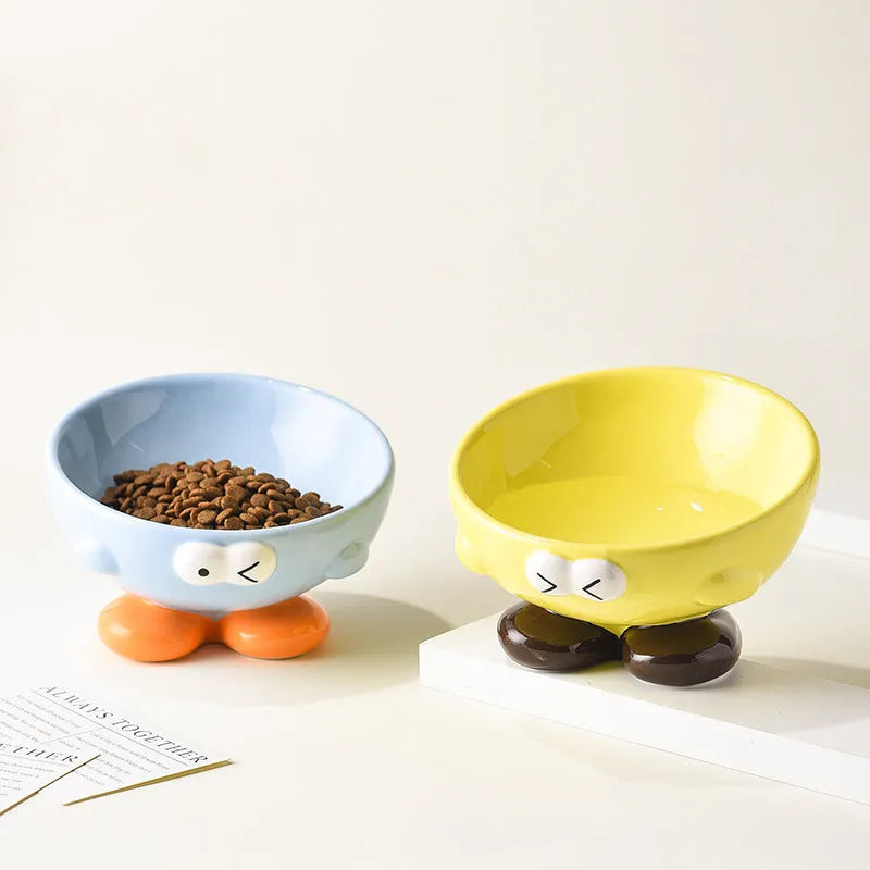 Blue ceramic pet bowl with tall, angled sides and a cute face design for cat or small dog feeding.