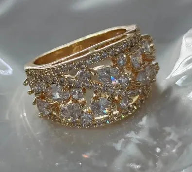 Women's round hollow copper fashion ring with a gemstone centrepiece, shown in gold and platinum colour options.