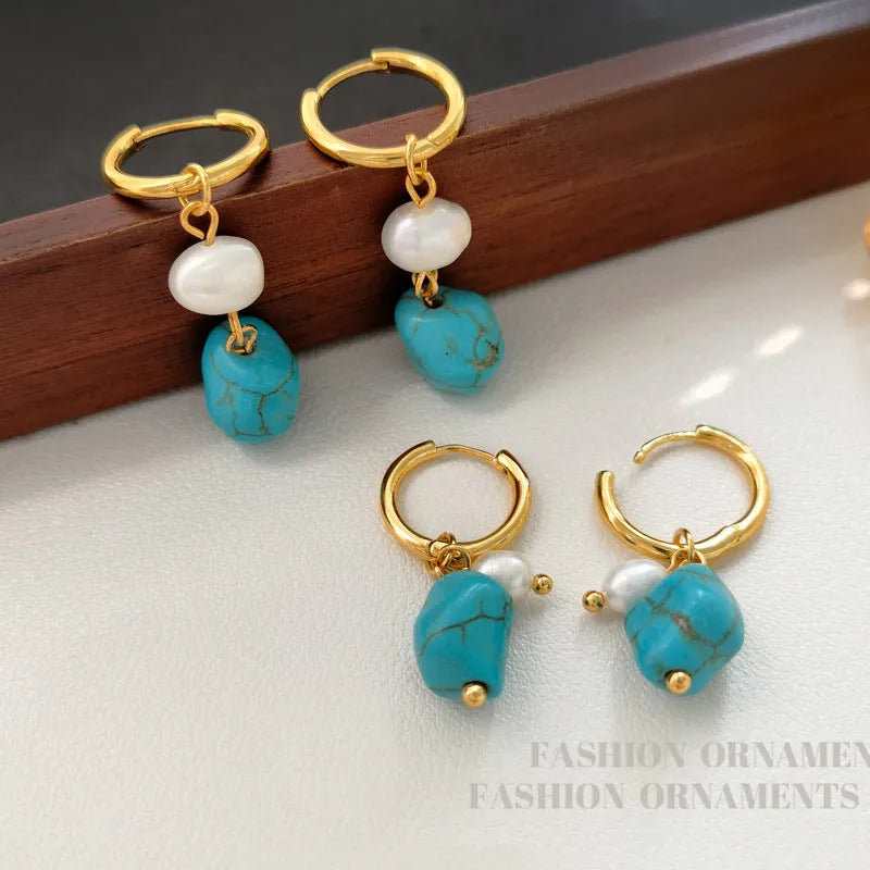 A pair of geometric clip-on earrings made of copper with turquoise and cultured pearls.