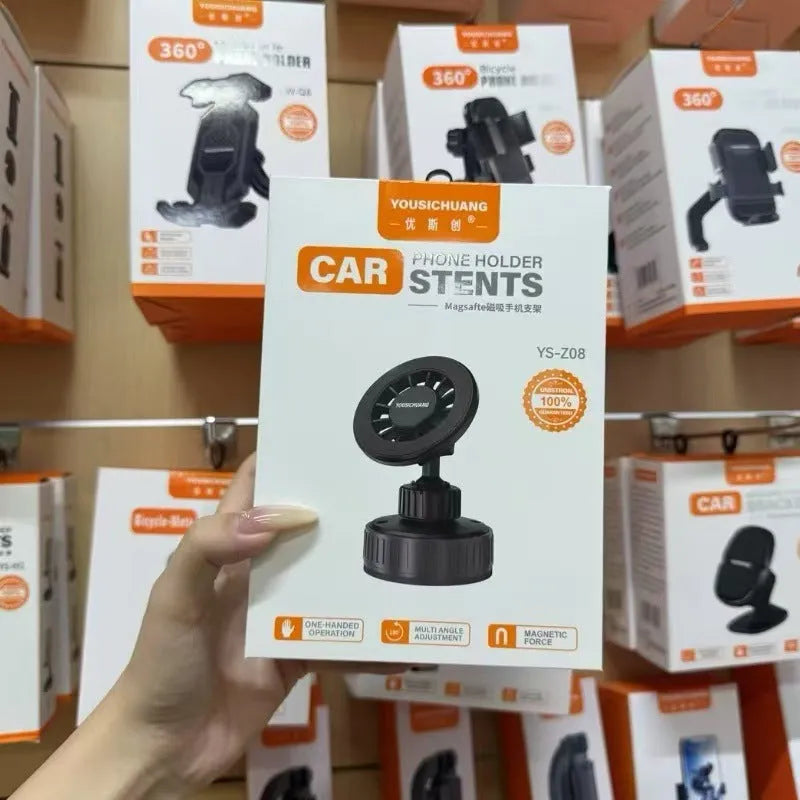 Black magnetic phone holder with 360-degree rotation and vacuum base on car dashboard