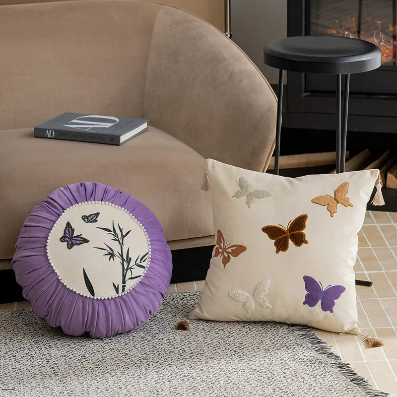 Square beige cushion with embroidered black butterfly pattern in Chinese style.
