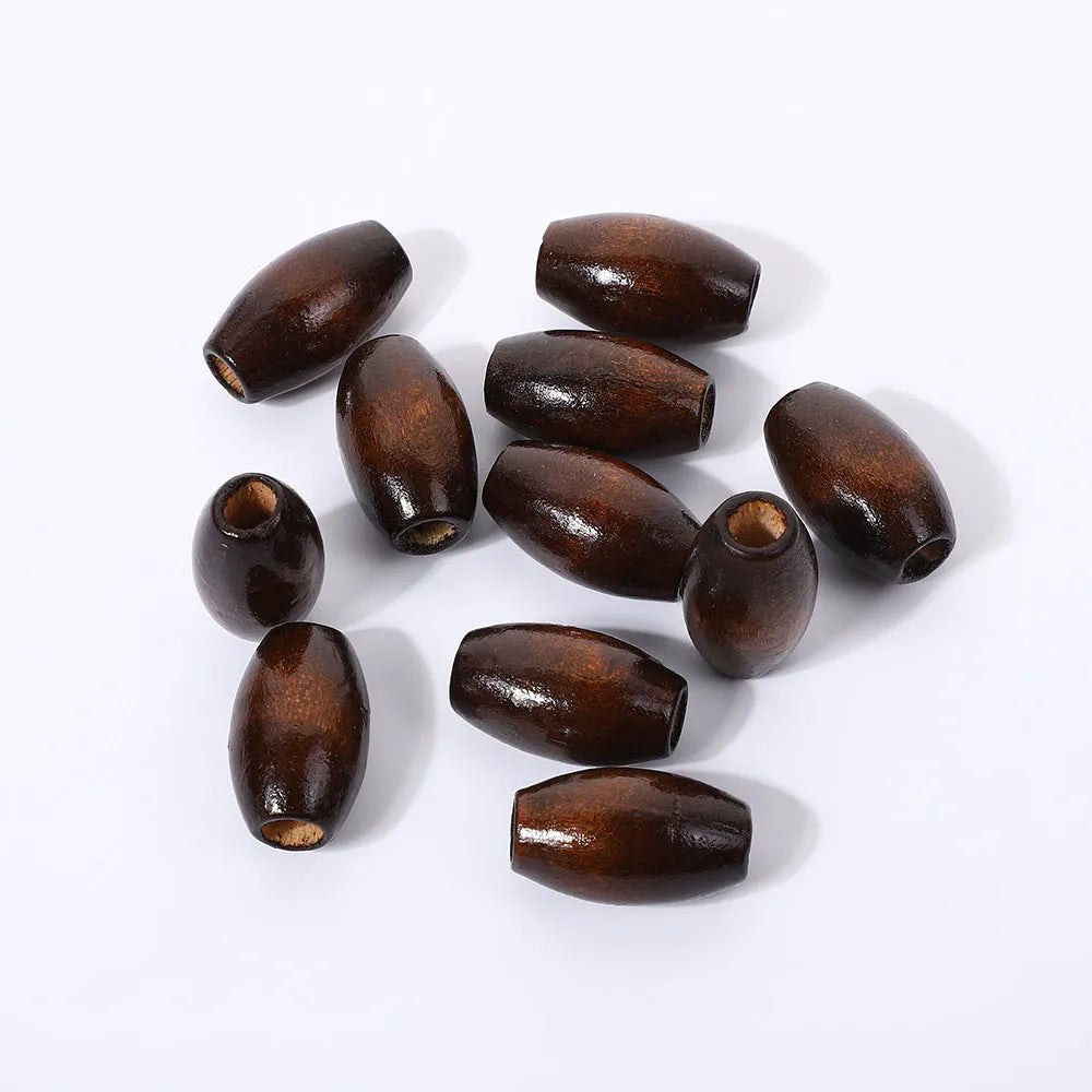 Dark coffee coloured oval wooden beads with M-shaped raised texture, 25mm size