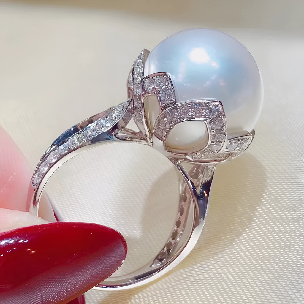 Copper female baroque pearl receptacle ring with inlaid zircon stones in white gold colour on white background