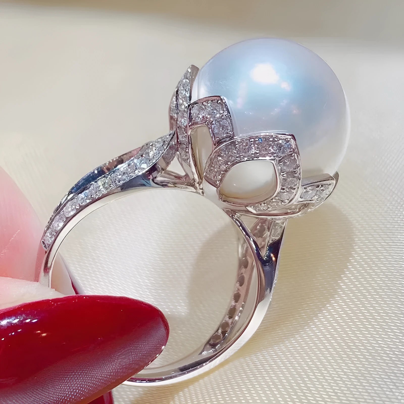 Copper female baroque pearl receptacle ring with inlaid zircon stones in white gold colour on white background
