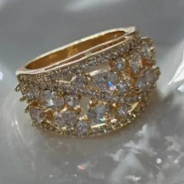 Women's round hollow copper fashion ring with a gemstone centrepiece, shown in gold and platinum colour options.