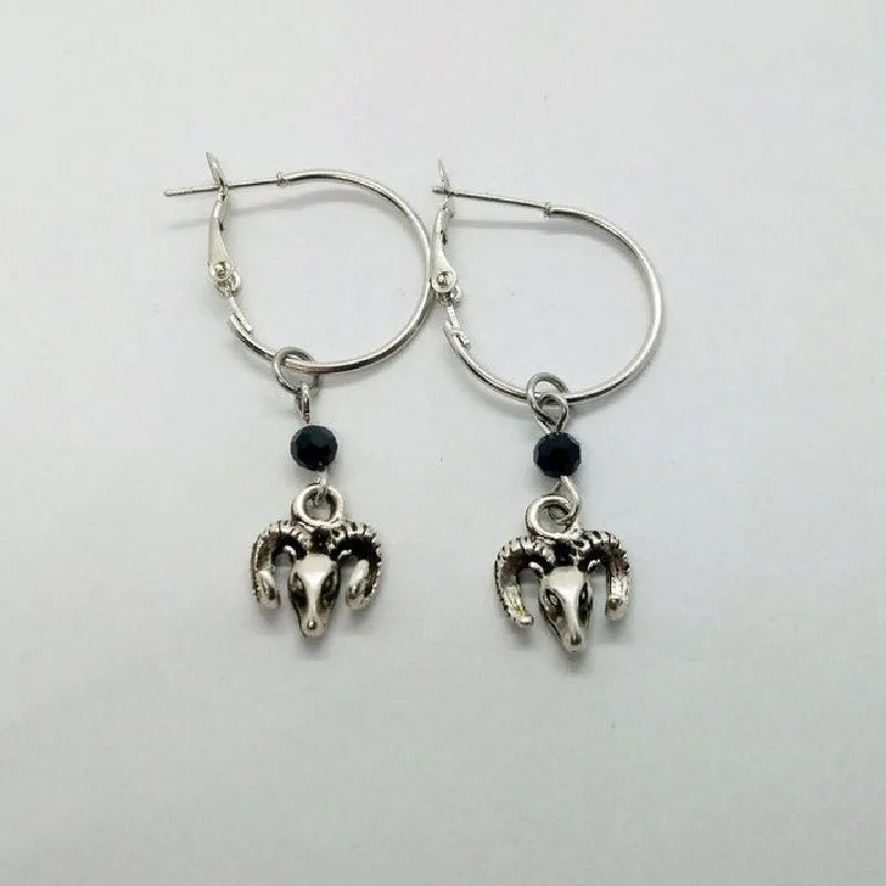 Silver-coloured alloy round hoop earrings for women with a Tibetan antelope design detail.