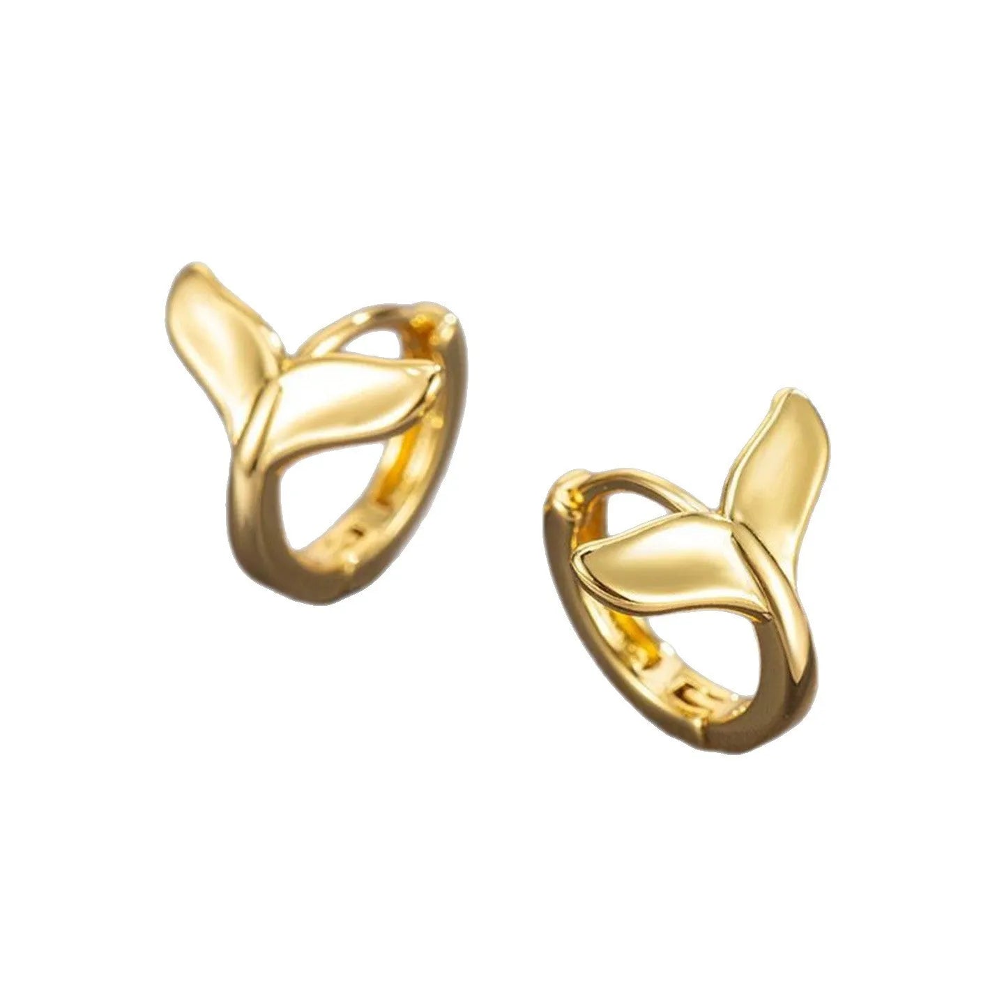 A pair of simple women's fishtail earrings in a gold tone finish on a copper base.