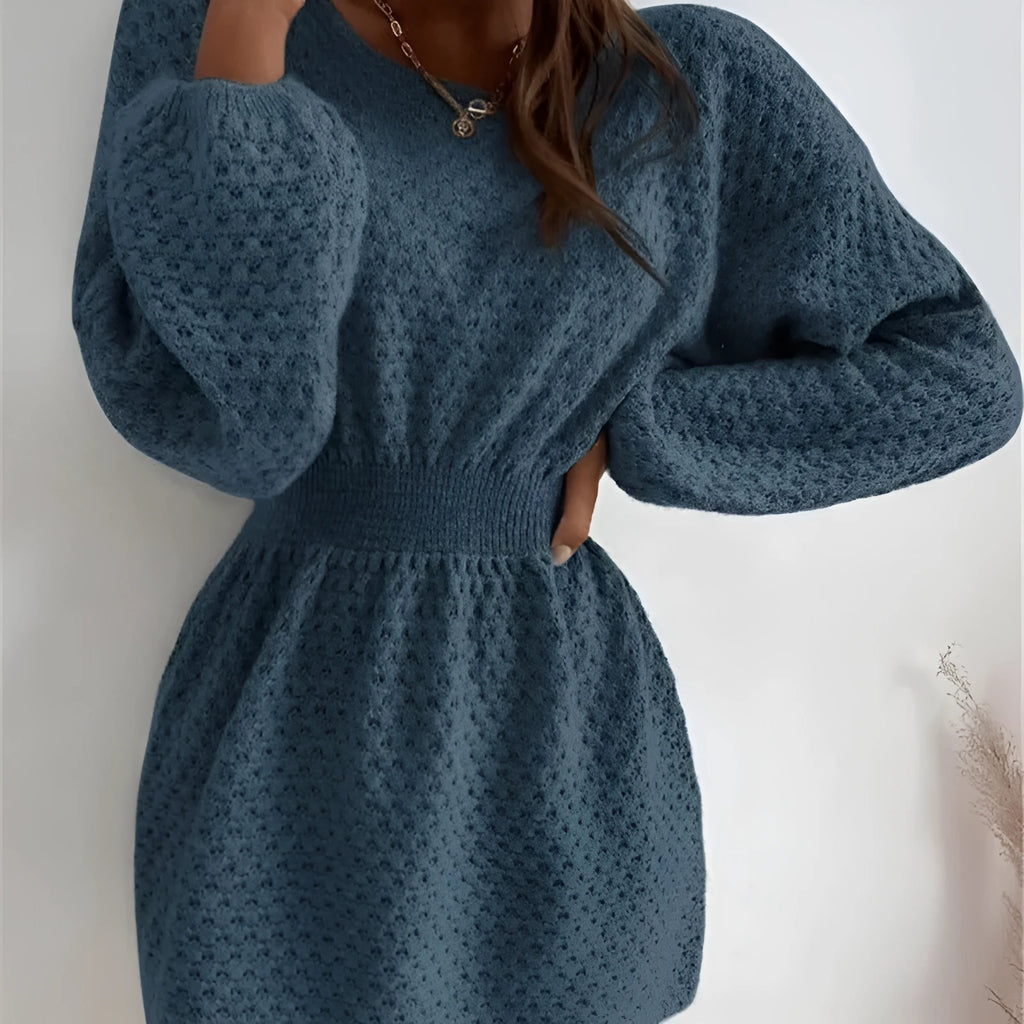 Blue women's knitted dress with crocheted flowers, a round neck, fitted waist, and long sleeves.