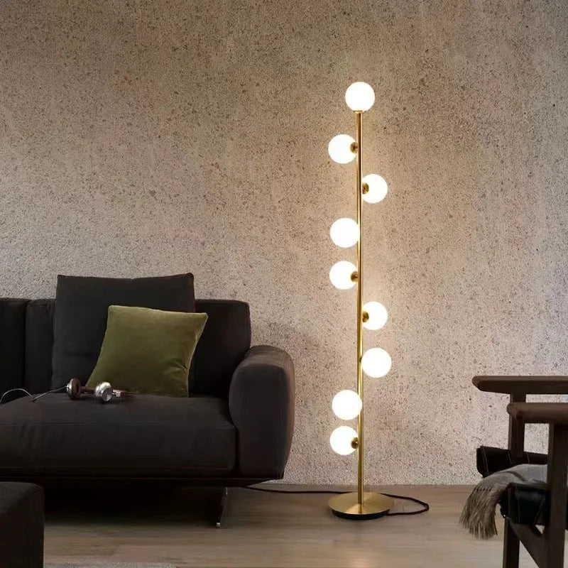 Tall minimalist Nordic floor lamp with wrought iron frame, glass shade, and circular marble base.