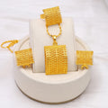 Golden bridal jewellery set comprising a copper necklace, earrings, and ring on a display.