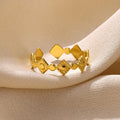 Geometric gold diamond titanium steel women's ring on white background