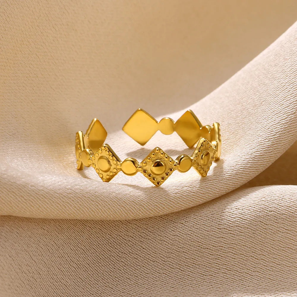 Geometric gold diamond titanium steel women's ring on white background