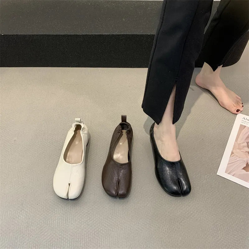Women's black split toe horseshoe design pumps with a chunky low heel and round toe.