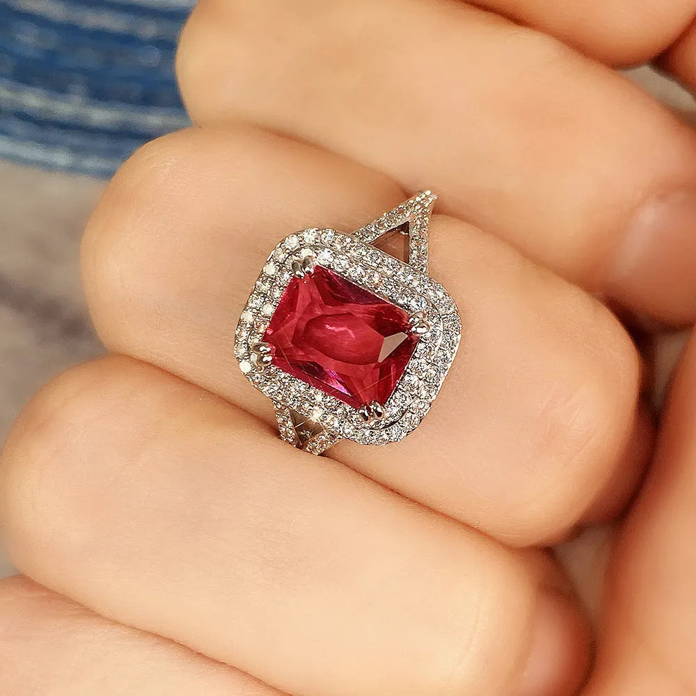 Geometric square red copper ring with a central rhinestone, shown from above.