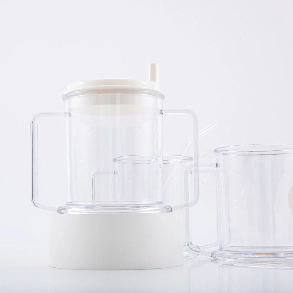 Transparent spill-proof plastic drinking cup on a plain background