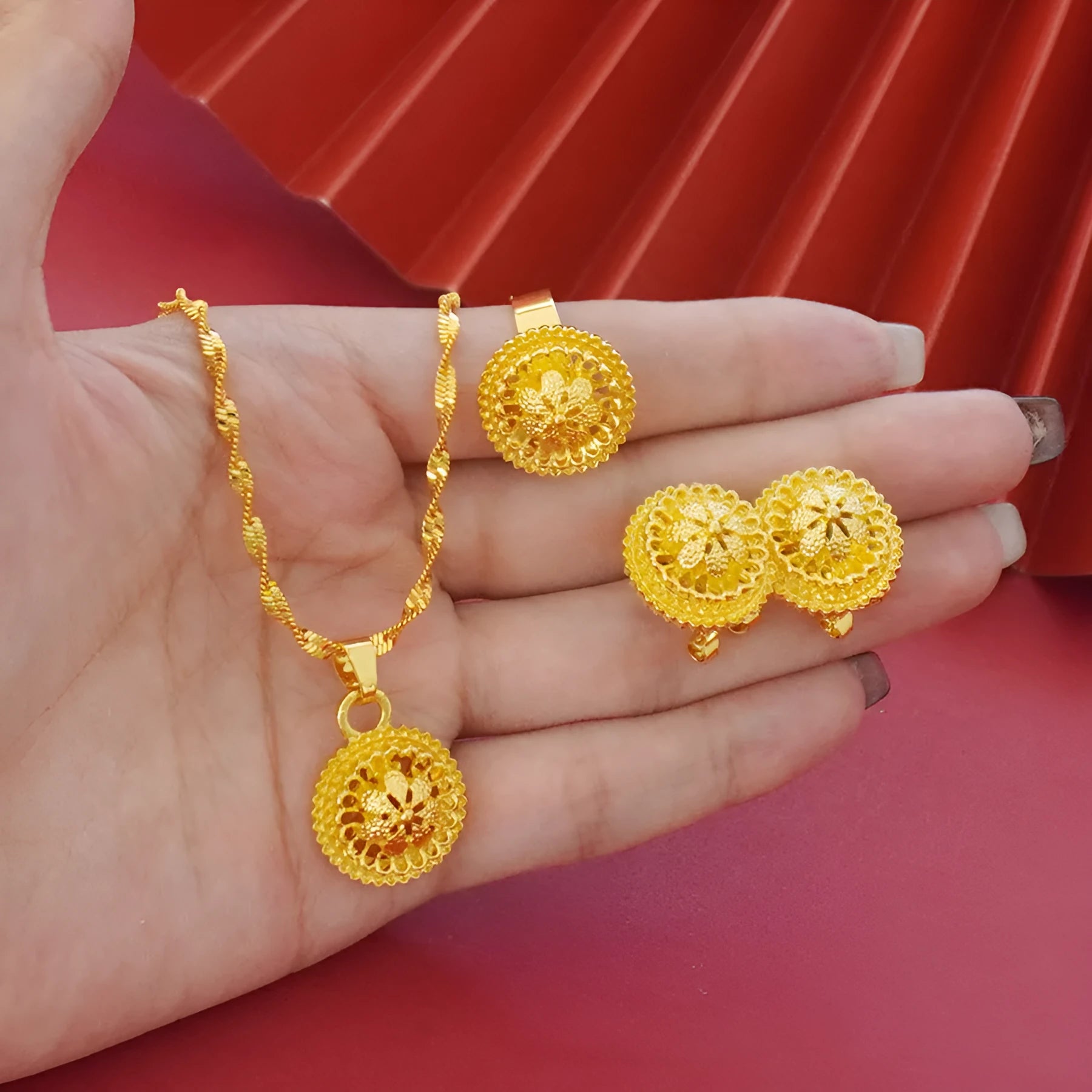 Gold-plated three-piece jewellery set with Middle Eastern flower design, showing necklace, pendant earrings, and ring.