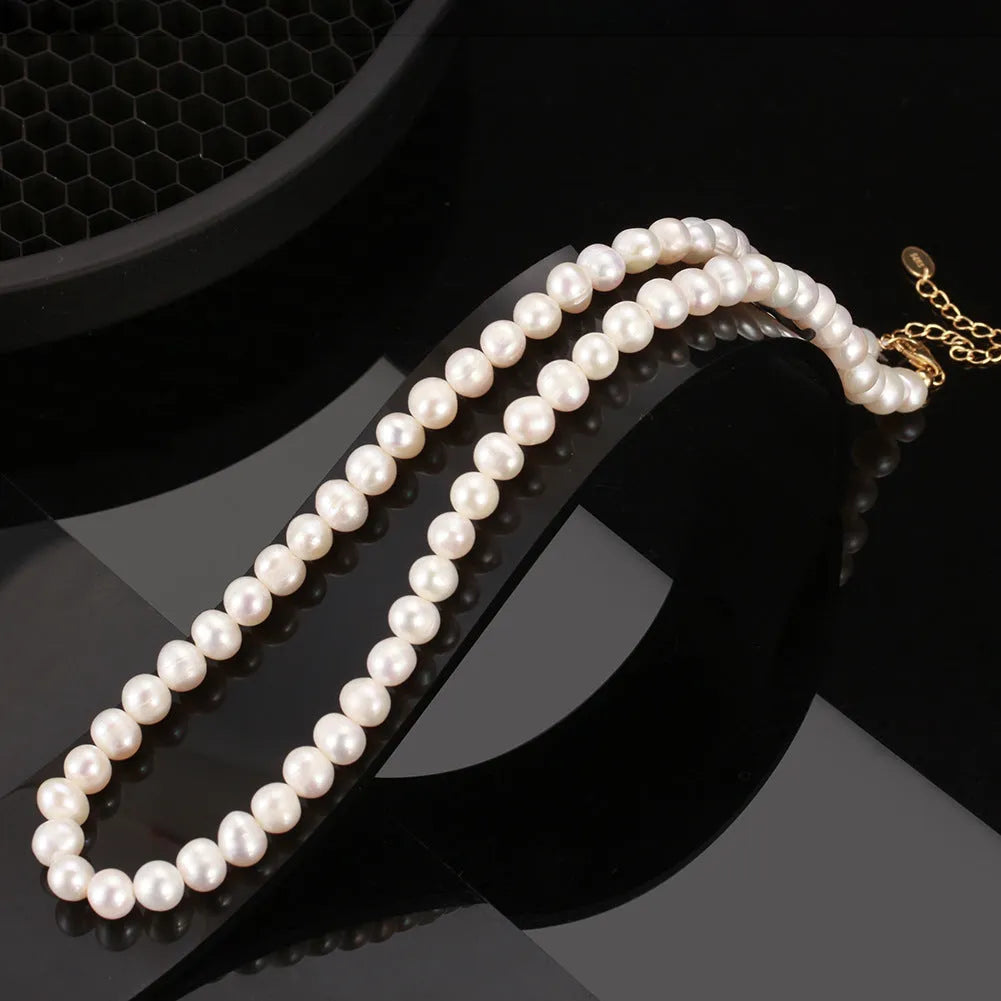 Women's adjustable sterling silver necklace with natural freshwater pearls.