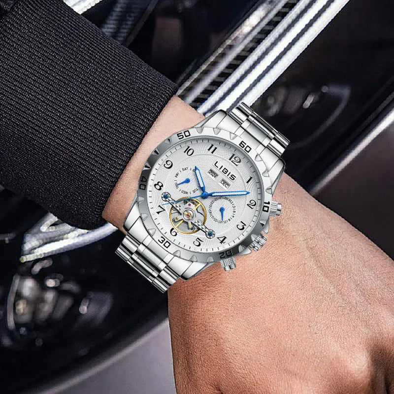 Silver stainless steel men's automatic perpetual calendar watch with sapphire glass on a wrist.