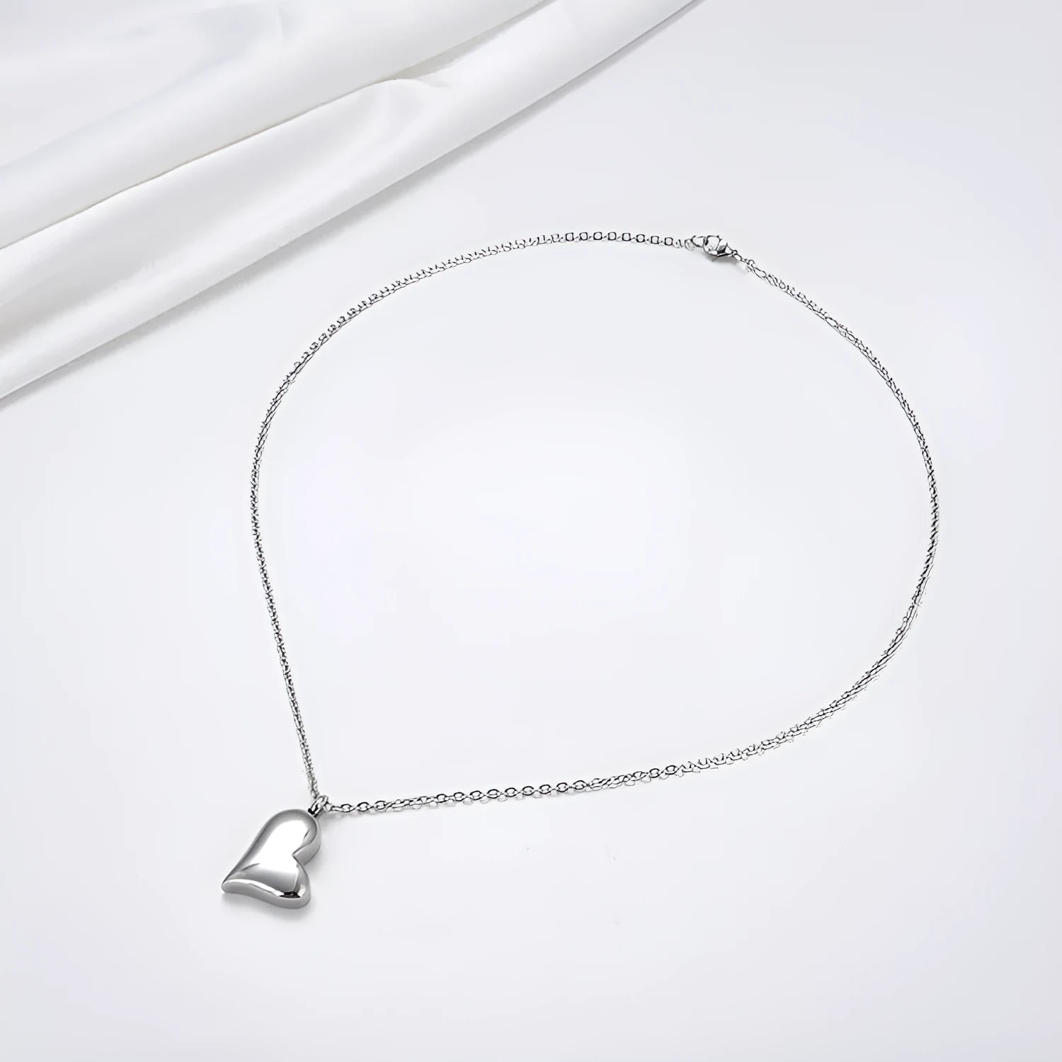 Silver curved peach heart stainless steel pendant necklace on adjustable length chain